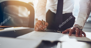 stock-photo-close-up-business-man-signing-contract-making-a-deal-classic-business-334043420